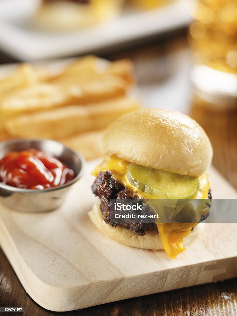 burger slider close up on wood cutting board burger slider close up on wood cutting board shot with selective focus American Culture Stock Photo