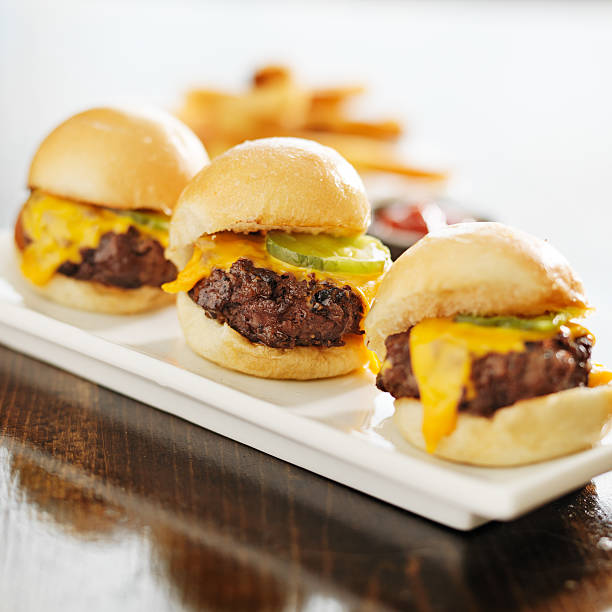 istock three burger sliders with cheese and pickle 504741207