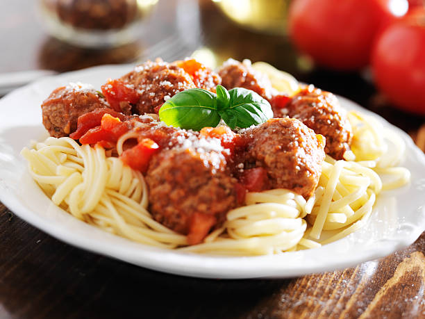 istock spaghetti and meatballs with basil garnish 504741311