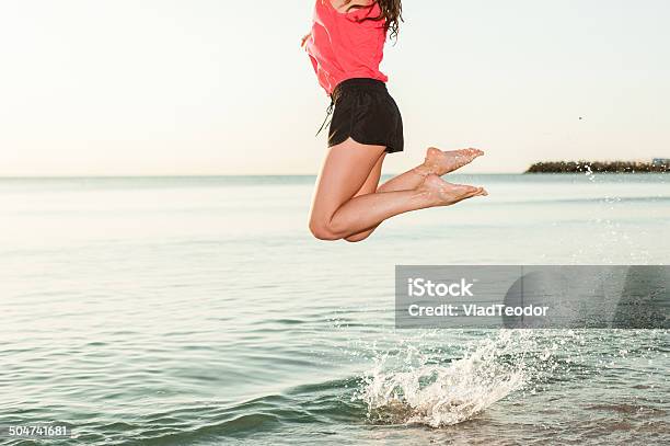 Happy Woman Jumping In Sea Sunrise Closeup Stock Photo - Download Image Now - Active Lifestyle, Activity, Adult