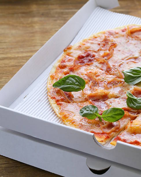 traditional Italian pizza with prosciutto ham and basil