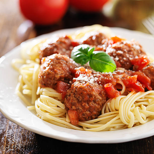 istock spaghetti and meatballs with basil garnish 504742013