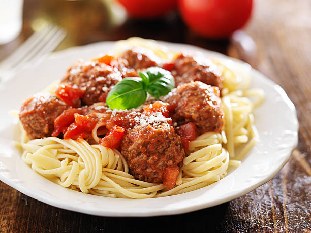 istock spaghetti and meatballs with basil garnish 504742039