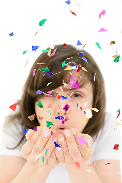 istock Young woman blows confetti with palms 504742062