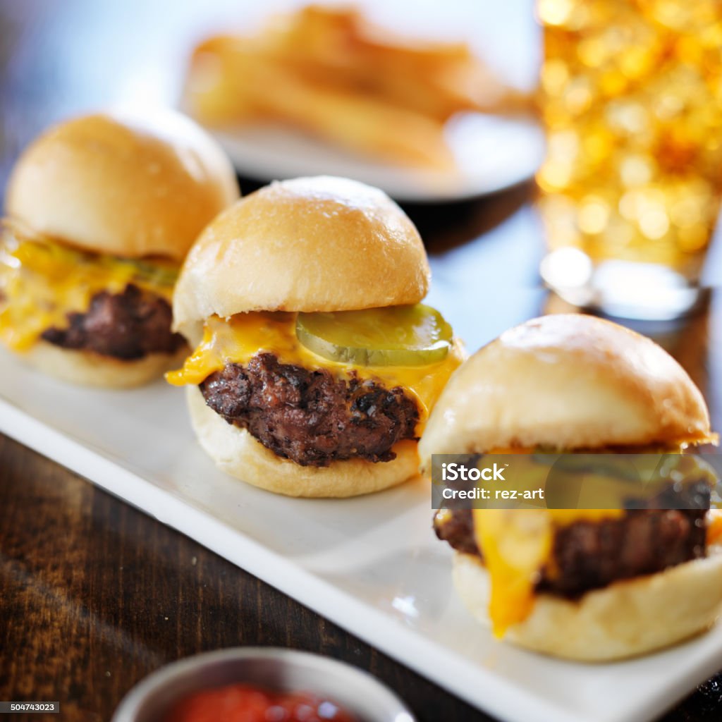 burger sliders with melted cheese and pickle burger sliders with melted cheese and pickle shot close up with selective focus Slider - Burger Stock Photo