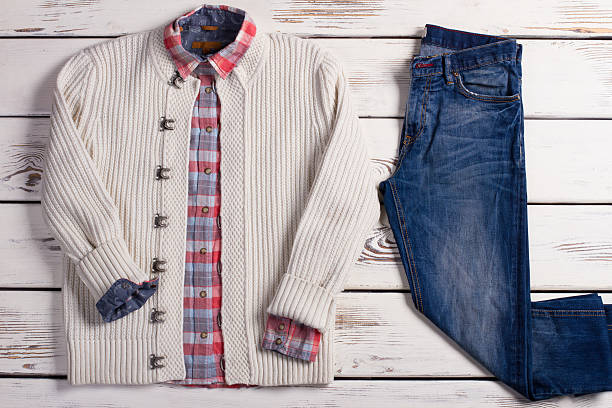 istock White knitted sweater with a checkered shirt and jeans. 504743922