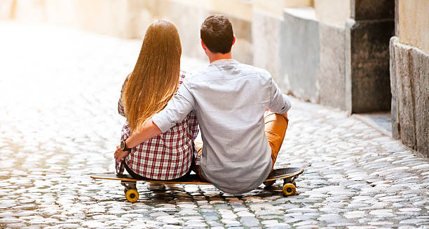 istock Young couple sitting on longboard 504745854