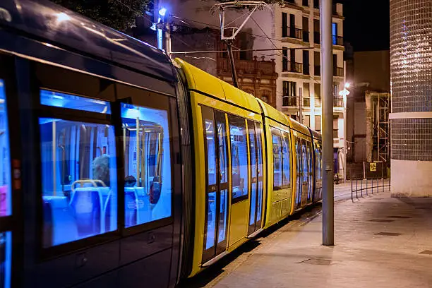 Tram in a night street of old town in Santa Cruz de Tenerife, Canary Islands, Spain. Tram was opened in 2007 and it is used by 50000 people daily.