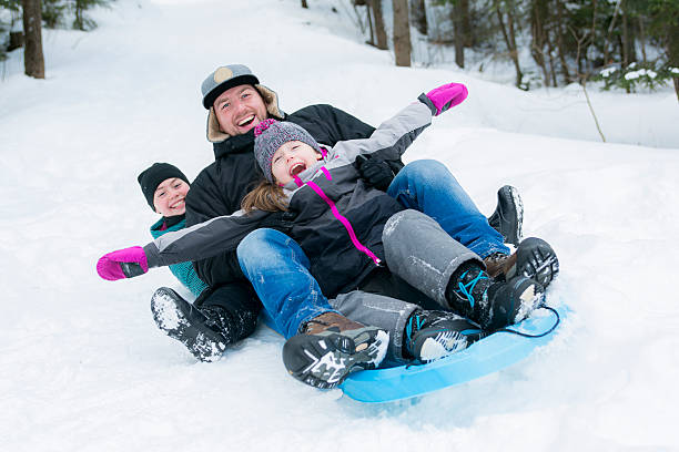 istock Father and son sledding at winter time 504748550