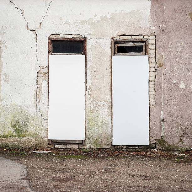 istock abandoned wooden house with boarded up windows 504752056