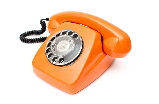 Orange retro telephone isolated on white background. View from above.