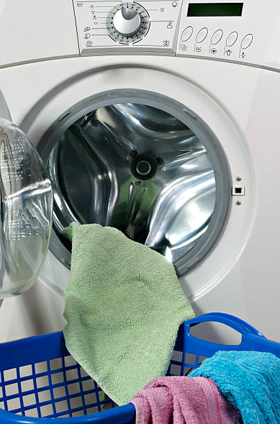 istock Clothes inside of washing machine taken closeup 504754782