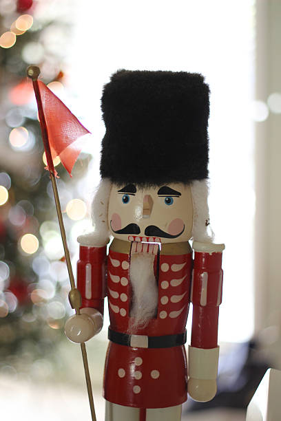 istock Wooden Nutcracker In Front Of Christmas Tree With Lights 504755650