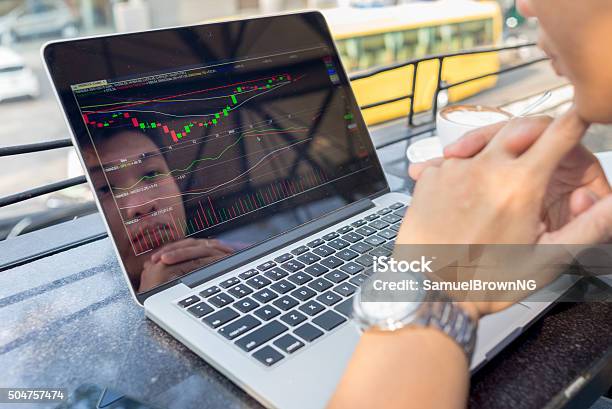 Investor Watching The Change Of Stock Market On Laptop Stock Photo - Download Image Now