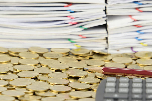 istock Brown pencil on stack of gold coins 504780090