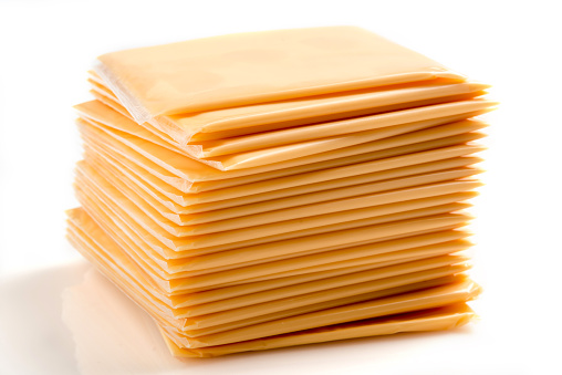 Heap of Sliced American Yellow Cheese on White Background