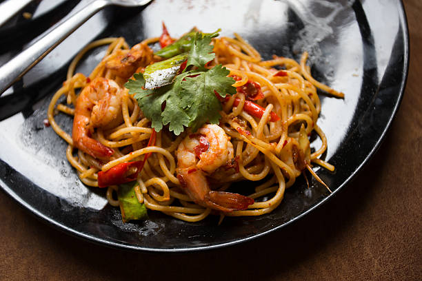 istock Hot spicy spaghetti seafood with bread . 504780528