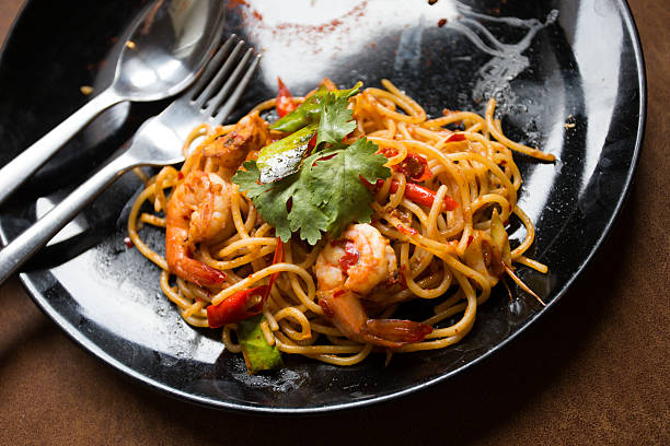istock Hot spicy spaghetti seafood with bread . 504780904