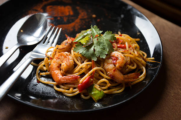 istock Hot spicy spaghetti seafood with bread . 504781060