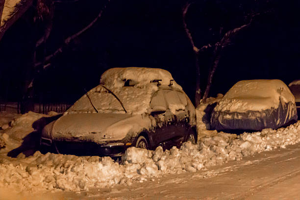 istock Cars parked, covered in snow at night 504781214