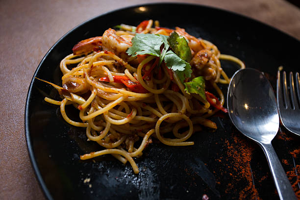 istock Hot spicy spaghetti seafood with bread . 504781324