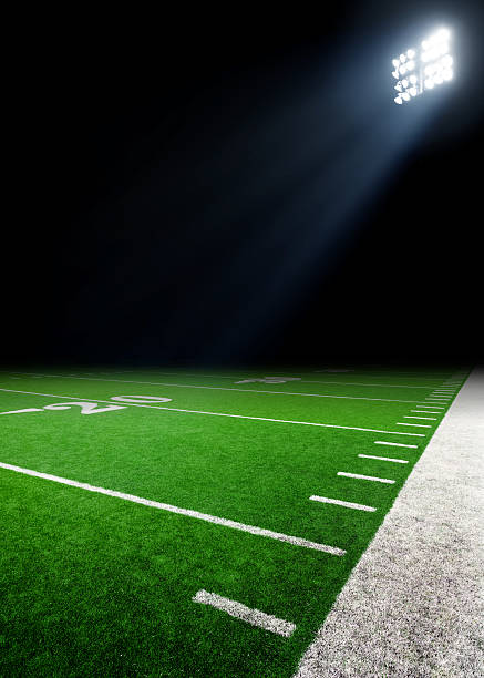 Football field Football field at night with stadium lights. traditional sport stock pictures, royalty-free photos & images