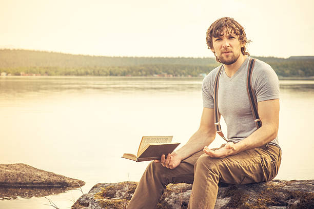 istock Young Man reading book outdoor Summer vacations Lifestyle 504782065