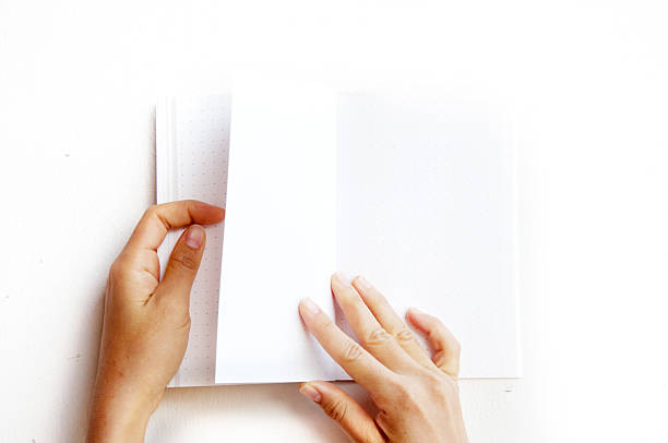 istock overhead view of hands holding a blank book 504782476