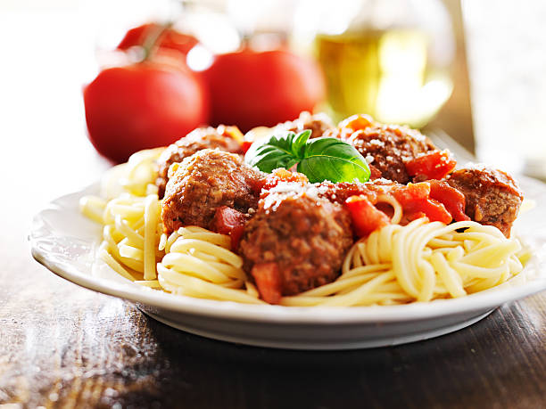 istock spaghetti and meatballs with basil garnish 504782961