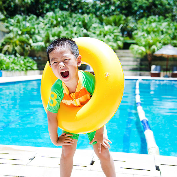 istock boy with swimming tube 504784179