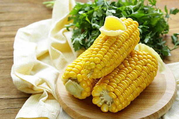 istock fresh boiled cob corn on a wooden plate 504784471