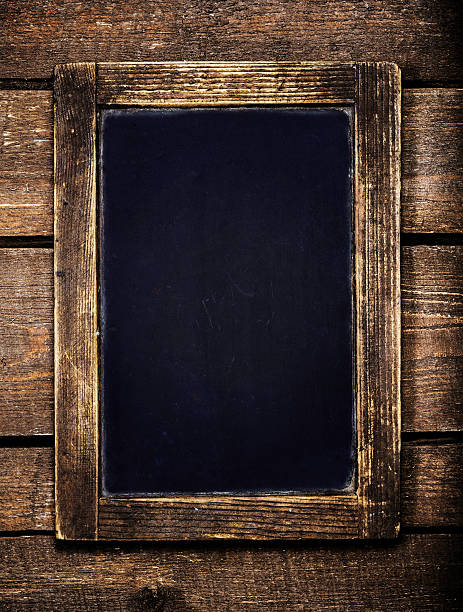 istock Aged  menu blackboard over vintage wooden background. Empty 504785463