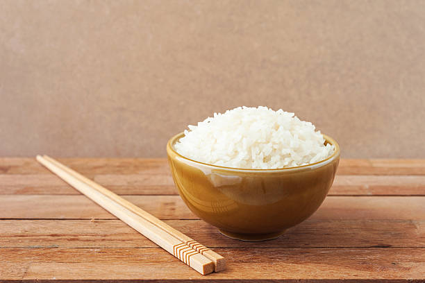 istock White rice in brown bowl with wood chopsticks 504785884