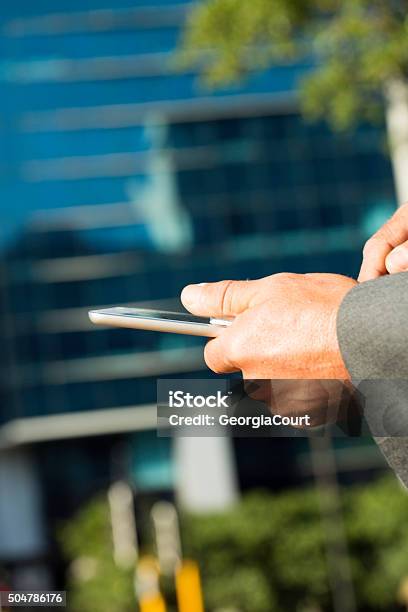 Businessman Ordering Uber Taxi On Smart Phone Stock Photo - Download Image Now - Adult, Business, Business Finance and Industry