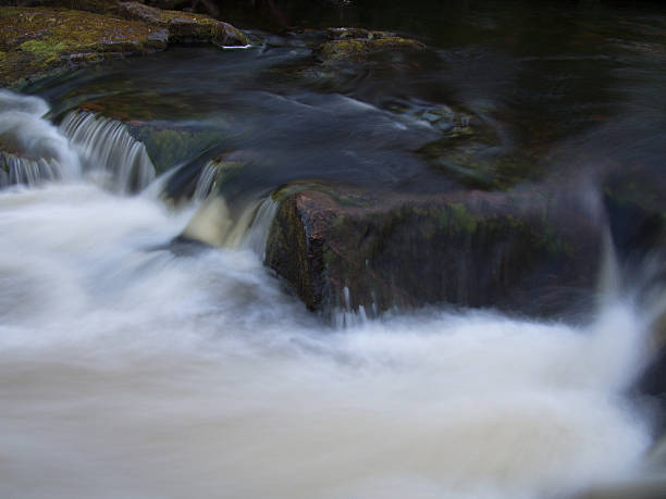 istock Water falls from the rocks with splashes 504786235