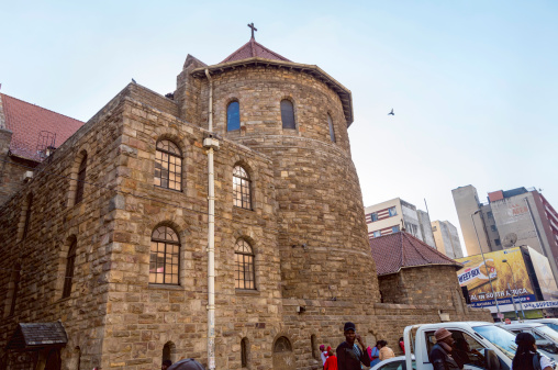 Johannesburg, South Africa - August, 2nd 2014: St Mary Cathedral in Johannesburg, built in 1926. An Anglican Cathedral where many historical people were buried and many memorial inscriptions from the world wars can be seen. Famous for its restored organ, the largest in Southern Africa. People seen outdoors in the busy city centre.