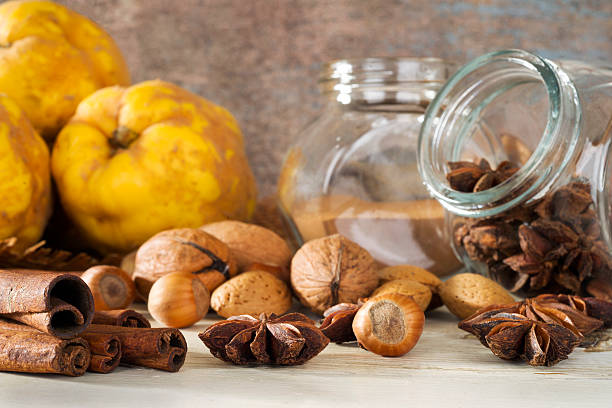 istock quinces, walnut, almonds, hazelnuts and   spices  on wooden table 504786397
