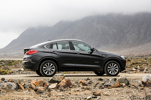 Atacama, Chile - November 14, 2015: New black crossover BMW F26 X4 is parked at the stone desert.