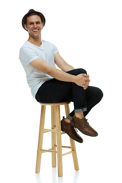 istock Happy hipster sitting on stool & looking at camera 504787535