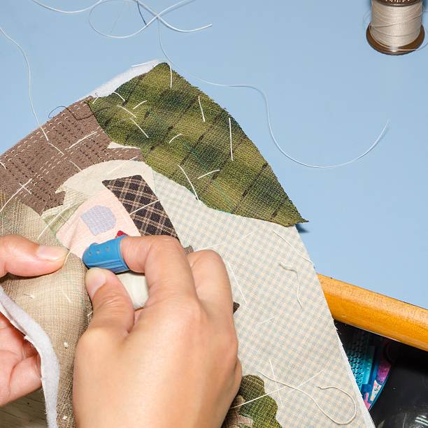 istock Woman's Hand Sewing Quilt 504787609