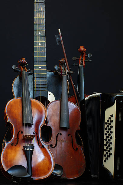 Front cropped shot of a violin without strings and broken harmonica
