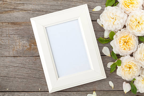 istock Blank photo frame and white roses 504787829