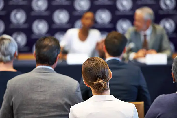 Shot of a group of businesspeople in a press conference