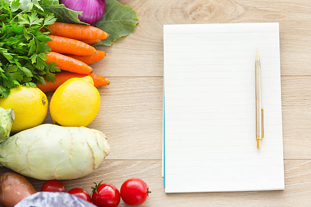 istock Blank recipe book on the table with vegetables 504788183