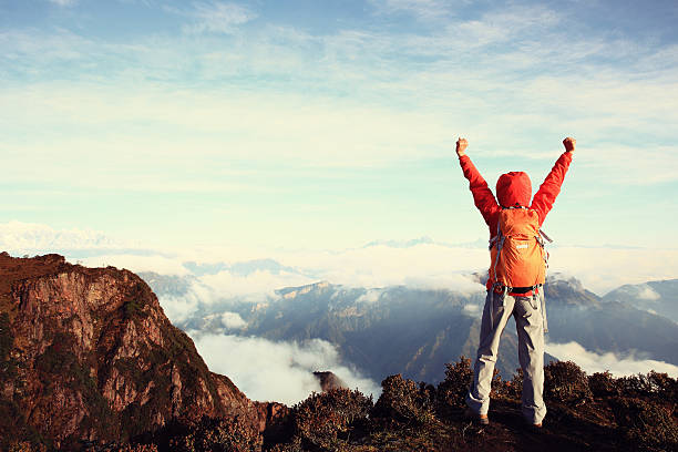 istock cheering young woman backpacker open arms to beautiful landscape 504794382