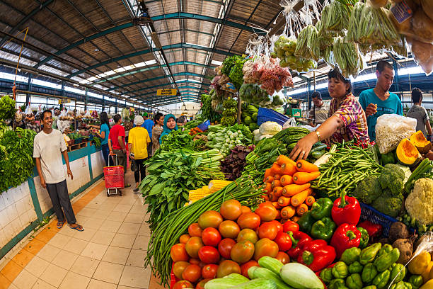 Tangerang market in Indonesia Jakarta, Indonesia - September 26, 2012: Vendor fixing the vegetables on display in her stall in a shop in Tangerang tangerang photos stock pictures, royalty-free photos & images