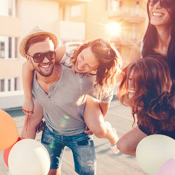 istock Friends piggyback on the rooftop 504795148