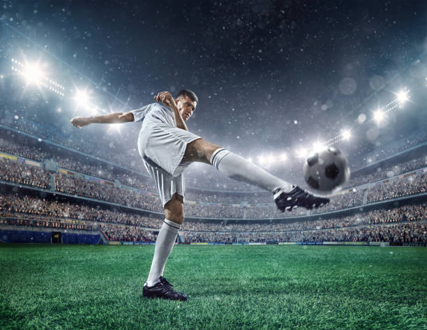 istock Football player kicking a ball 504795750