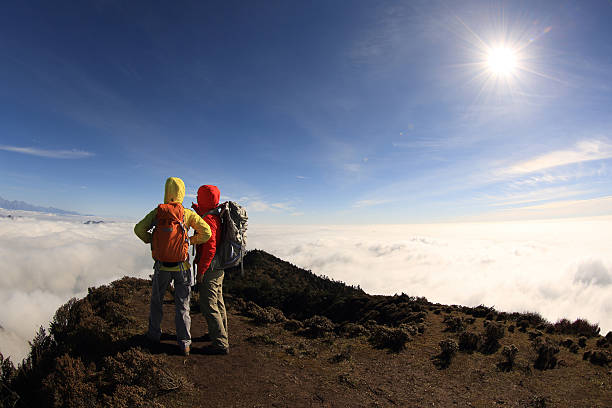 istock two successful  hikers on beautiful rolling clouds mountain peak 504796250