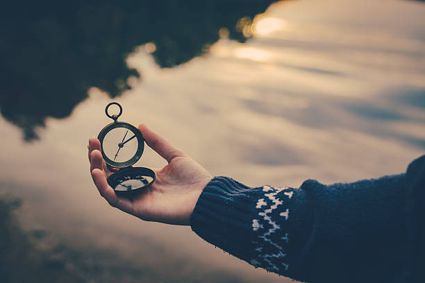Teenager girl  holding an old compass in hand stock photo